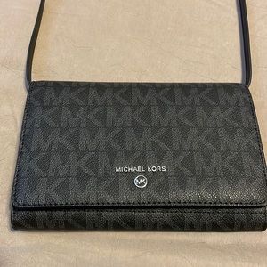 crossbody Black w/ MK logo  non adjustable strap. 3 inside pockets Like new